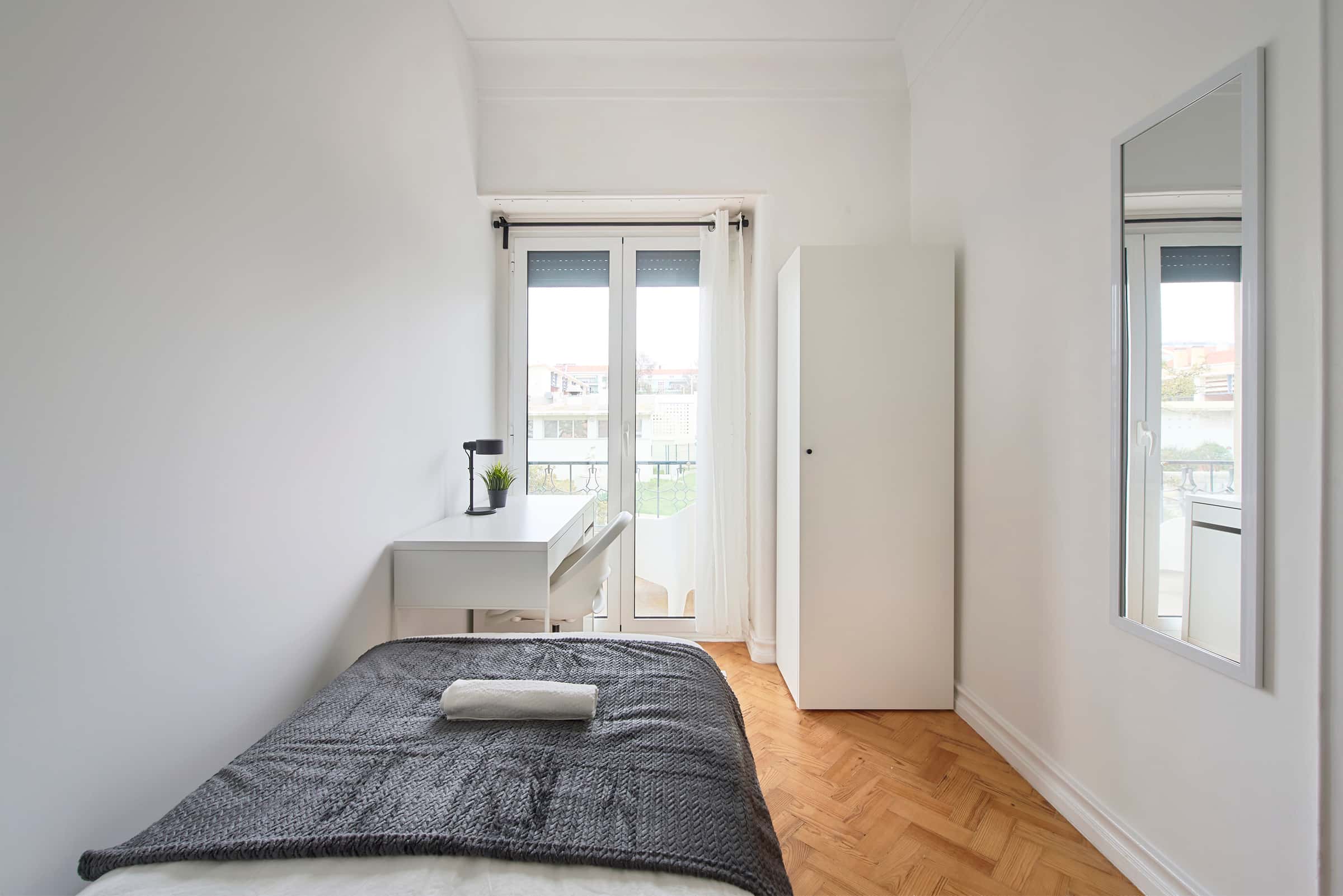 Bedroom with balcony in a 9-Bedroom Apartment in Rua Jorge Ferreira de Vasconcelos, Lisbon - Room 3