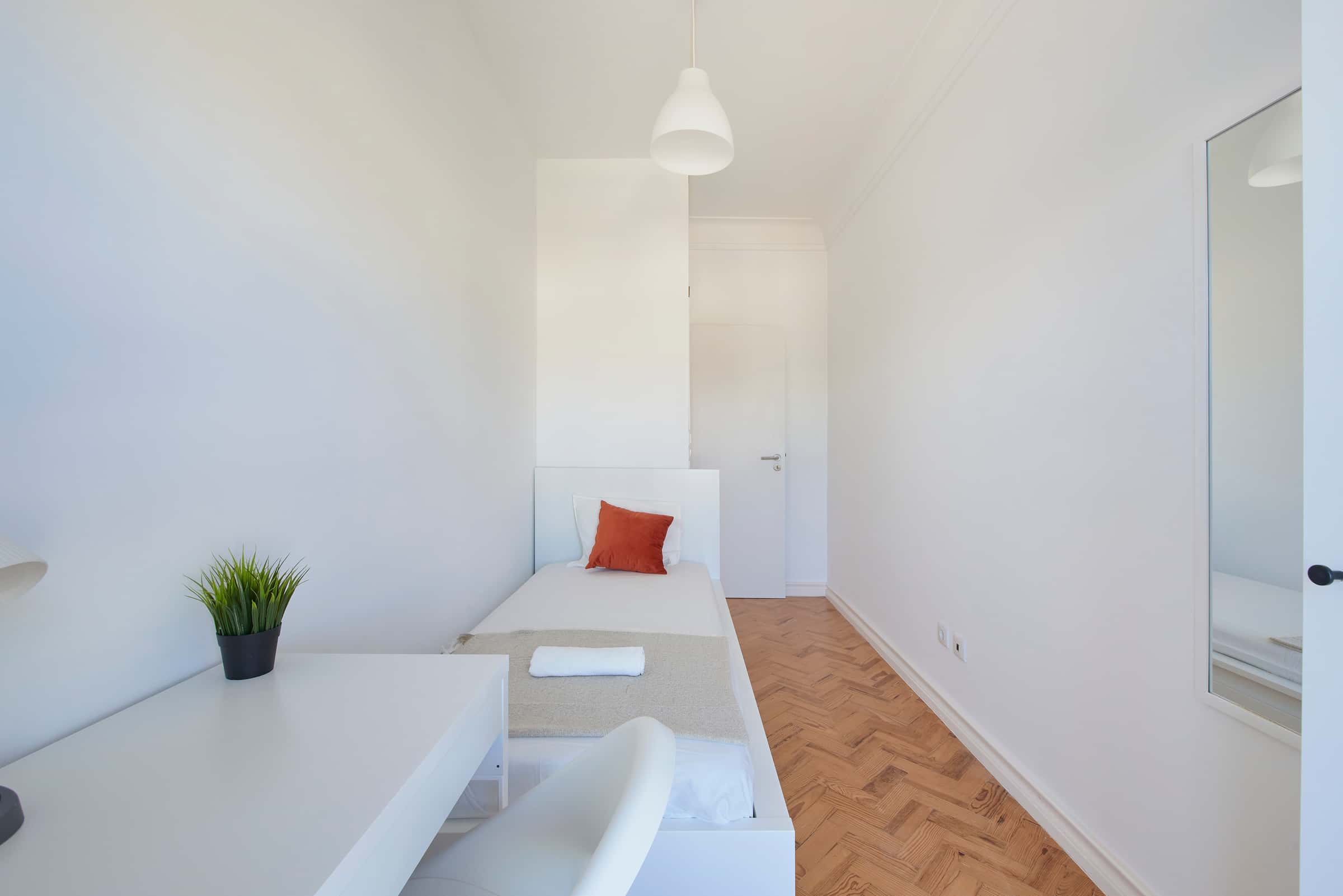 Bedroom with balcony in a 9-Bedroom Apartment in Rua Jorge Ferreira de Vasconcelos, Lisbon - Room 4